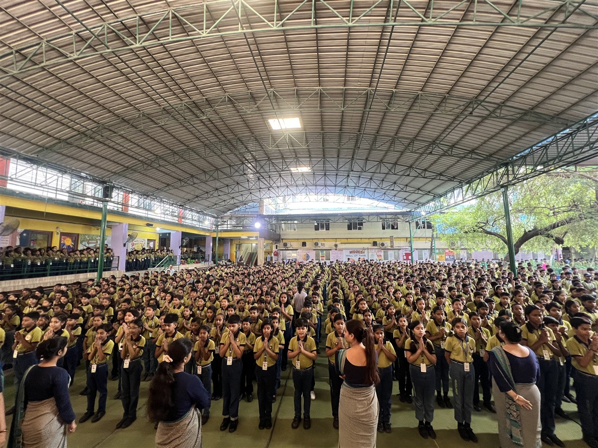 Students gathered in the covered school assembly area